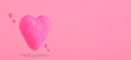 Shabby pink hearts on pastel pink background. St. Valentines day banner.の写真素材