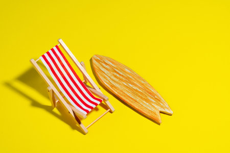Top view beach chair and surf board on yellow background.の写真素材