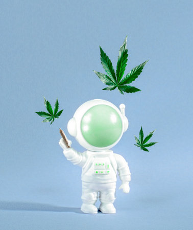 Cute little astronaut with joint and marijuana leaves on blue background.