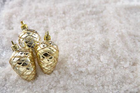 A group of Christmas pine cone on a snow background with top down angleの写真素材