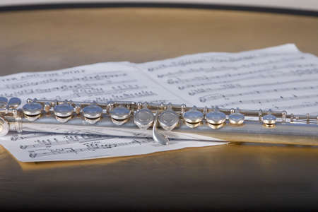 Silver flute on sheet music
