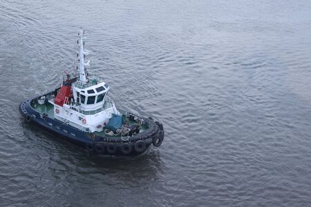 tug boat floating in the harbor waiting for a ship to pullの写真素材