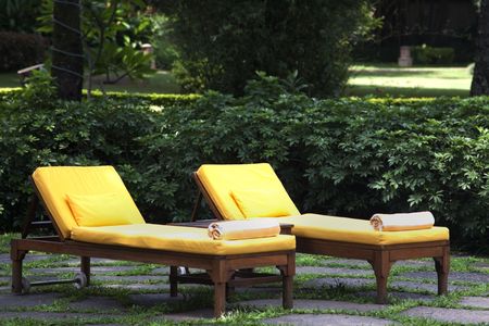 Two yellow lounge chairs on a patioの写真素材