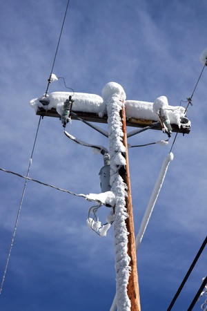 a power pole against the blue sky after a snow stormの写真素材