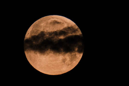 Flower blood super moon May 2021 with passing clouds
