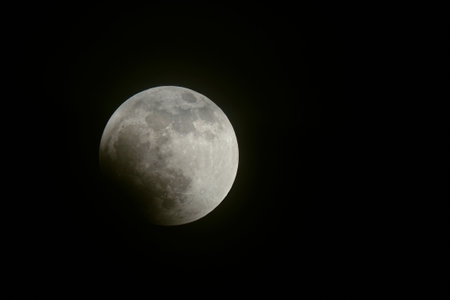 May 2022 Total Lunar Eclipse from the Northern Hemisphere, blood full moon beginning stage of the eclipseの写真素材