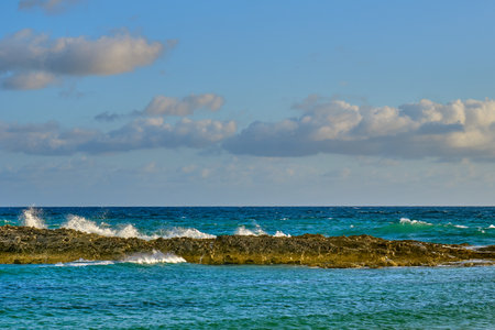 Waves crashing near the shore at sunrise in Nassau Bahamasの写真素材