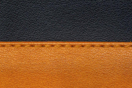 background of stitching details on brown and black leatherの写真素材