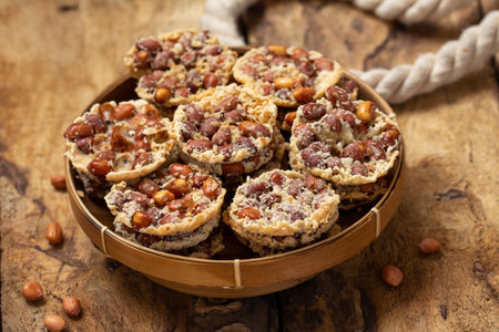 Traditional food from Indonesia known as peyek kacang is a deep fried savoury javanese cracker made from rice flour, peanut, lime leaves and other ingredientsの写真素材