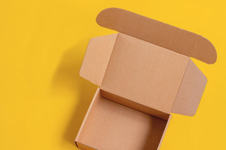 Opened cardboard box Isolated on yellow  background.の写真素材