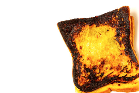 Slice of burnt toast isolated on white background