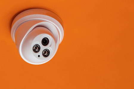 CCTV camera with orange background, Smart camera can record video all day long to guard and scout the surroundings.の写真素材