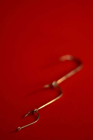 A set of fishing hooks in various conceptive situations.の写真素材