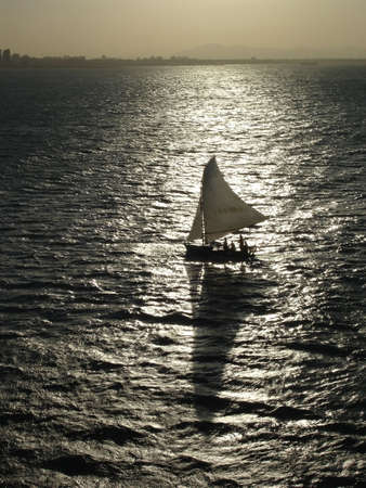 A sail boat silhouette.の写真素材