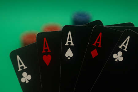A great hand in a poker game with a green background.の写真素材