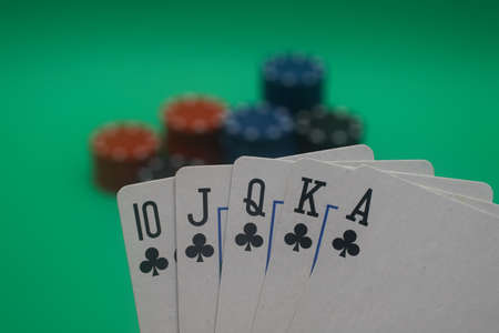 A great hand in a poker game with a green background.の写真素材