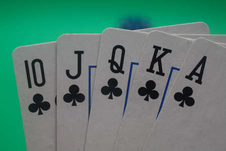 A great hand in a poker game with a green background.の写真素材