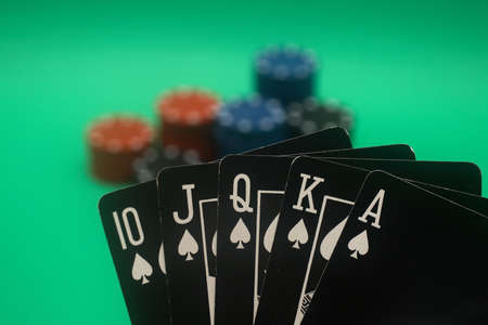 A great hand in a poker game with a green background.の写真素材