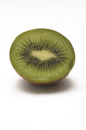 A kiwi, cut in half, isolated on a white background.の写真素材