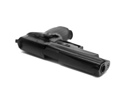 An automatic black pistol isolated on a white background.の写真素材