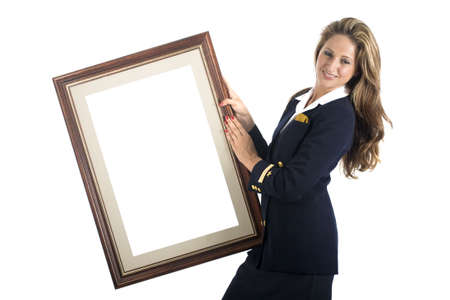 A young brazilian model in a studio shot, wearing a seaman's (or seawoman's) uniform, isolated on white and holding a picture frame..の写真素材