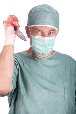 A 60 year old surgeon holding a bloody nice. Malpractice concept.の写真素材