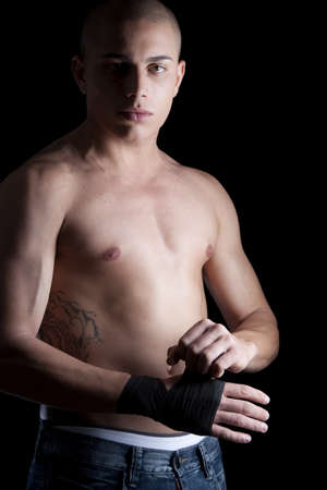 A good looking, muscular built, man on a black background.の写真素材