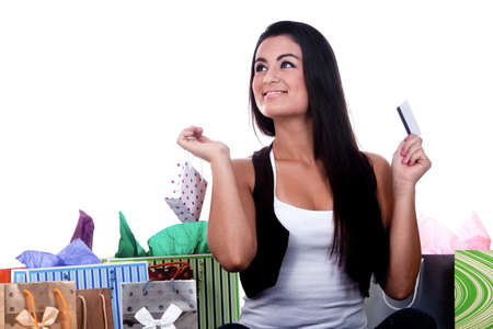A happy girl holding shopping bags, on a white background.の写真素材