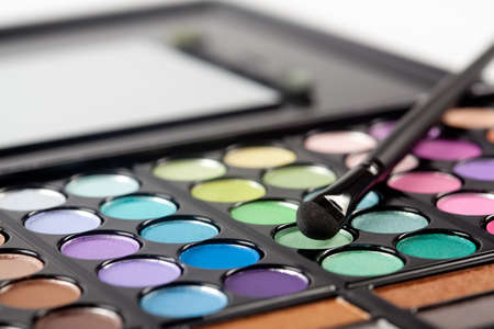 A colorful image on an eyeshadow pallet with a brush.の写真素材