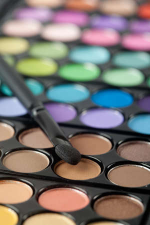 A colorful image on an eyeshadow pallet with a brush.の写真素材