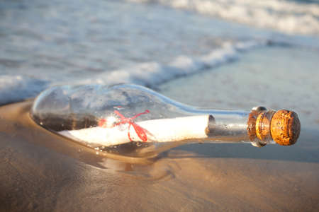 A message inside a glass bottle, washed up on a remote beach.の写真素材