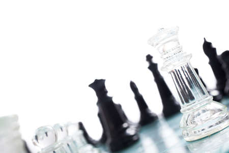 Black and transparent glass chess pieces, on a see through chessboard.の写真素材