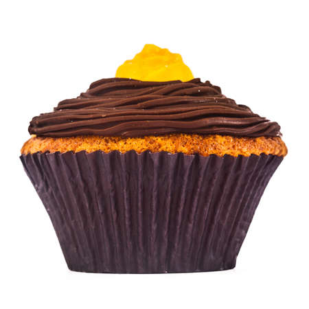 A gorgeous and delicious chocolate and carrot cupcake isolated on a white background.の写真素材
