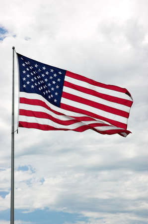 American flag against cloudsの写真素材