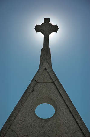 Silhouette of the cross atop Holy Cross Church granite entryway.の写真素材