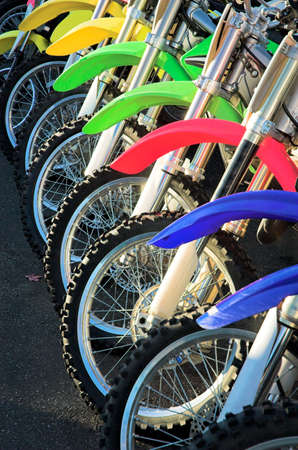 A row of brightly colored motorcycles ready to be sold.の写真素材