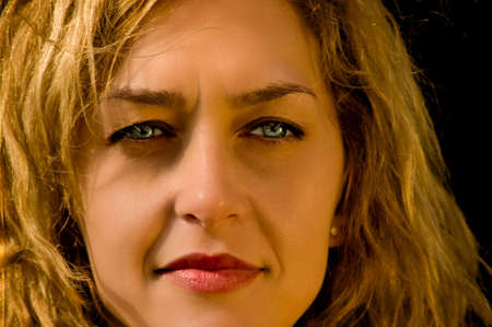 A young blonde woman with a thoughtful expression