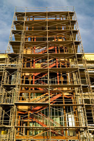 Metal safety scaffolding on a modern high-rise building under construction