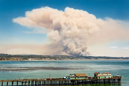 The Trabing wildfire near Watsonville, California, explodes into the sky over the Monterey Bayの写真素材