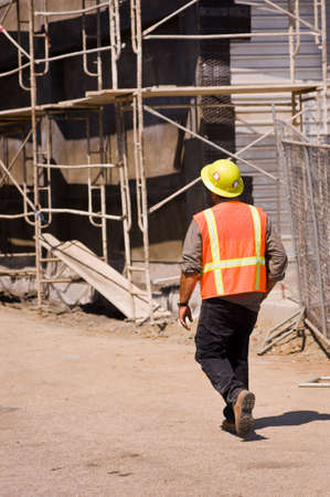 A safety officer trainee walking through a job siteの写真素材