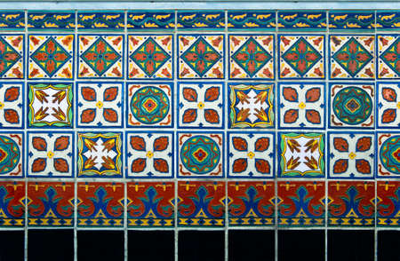 Antique tile wainscot on the front of an old building