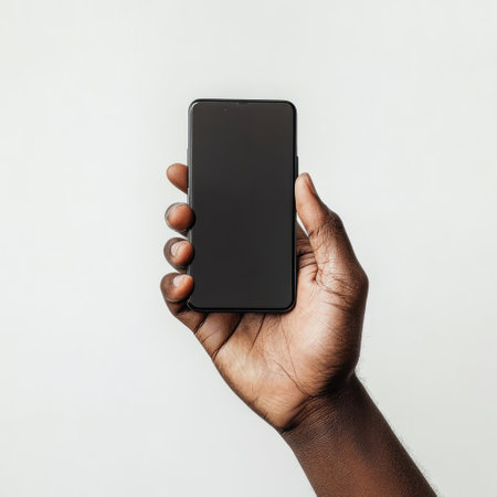 Black man hand holding smartphone with blank screen isolated on white background.の素材