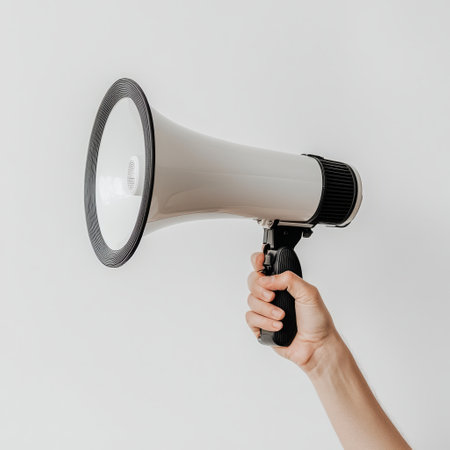 cropped shot of woman holding megaphone isolated on grey backgroundの素材