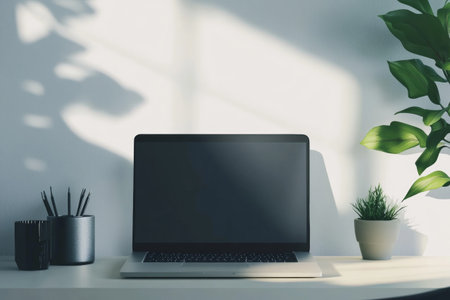 Close up of modern workplace with blank laptop, stationery and plant. Mock up, 3D Renderingの写真素材