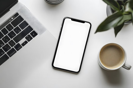 Smartphone with blank screen mockup on white office desk table.の写真素材