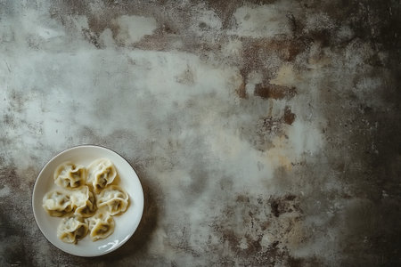 Russian dumplings pelmeni on a white plate on a gray background