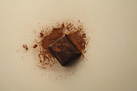 Chocolate bar with cocoa powder and chocolate splashes on a white background
