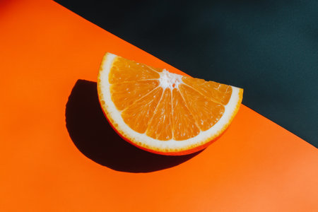 Orange slice on orange background. Flat lay, top view, copy space