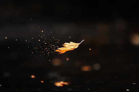 A single, golden leaf suspended in mid-air, surrounded by tiny particles, against a dark background,...