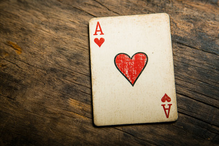 Ace of hearts on old wooden background. Vintage style toned pictureの写真素材